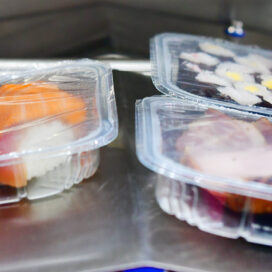 sushi in boxes transfer on automated conveyor systems for package.
